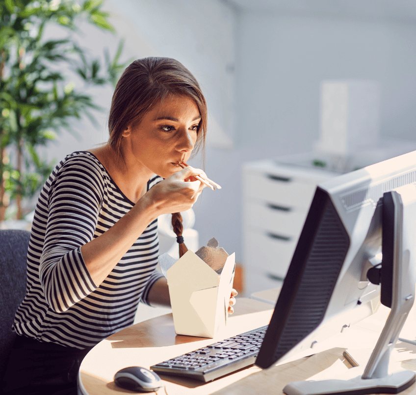Woman eating at her office desk